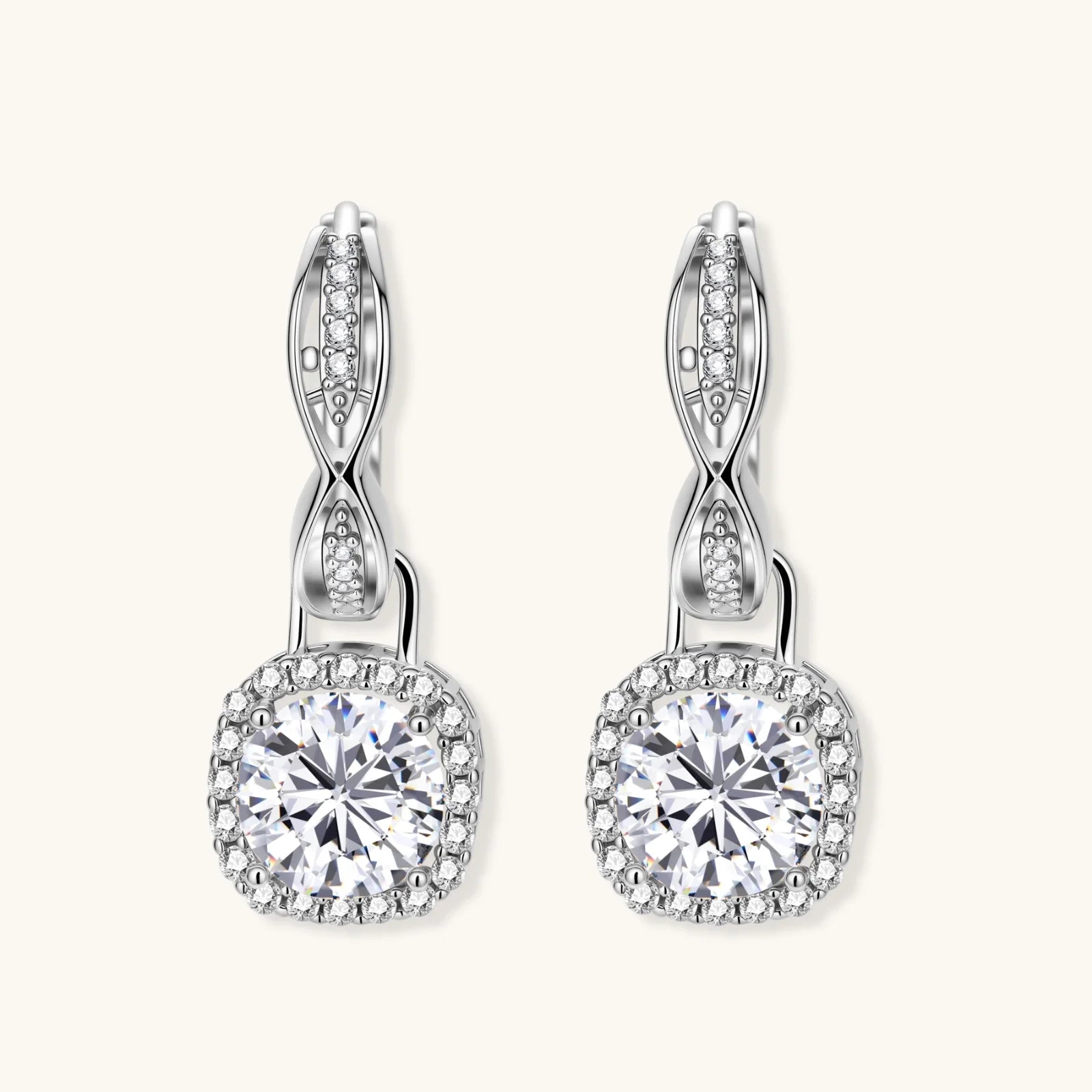 Sterling silver twisted hoop earrings with round moissanite stones in halo settings against neutral background.