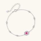 Elegant sterling silver chain bracelet featuring pink moissanite center stone in cushion halo setting with adjustable clasp