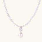 Dainty necklace with lavender crystal beads, freshwater pearls, geometric pendant, and large pearl drop on white background.