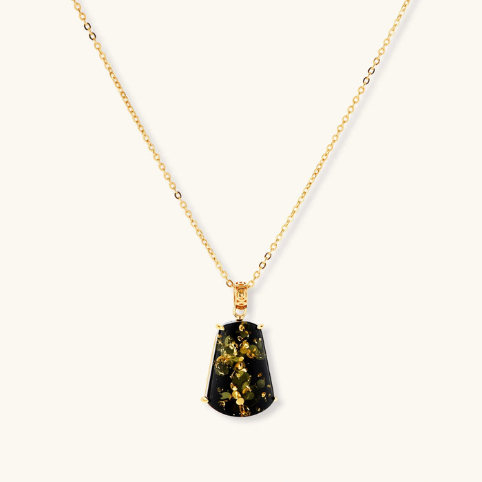 18k gold-plated necklace and earrings with green amber pendants featuring golden inclusions on cream background