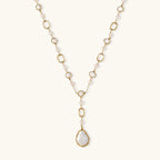 Long gold-plated necklace with alternating freshwater pearls and crystal bezels, featuring a large baroque pearl pendant