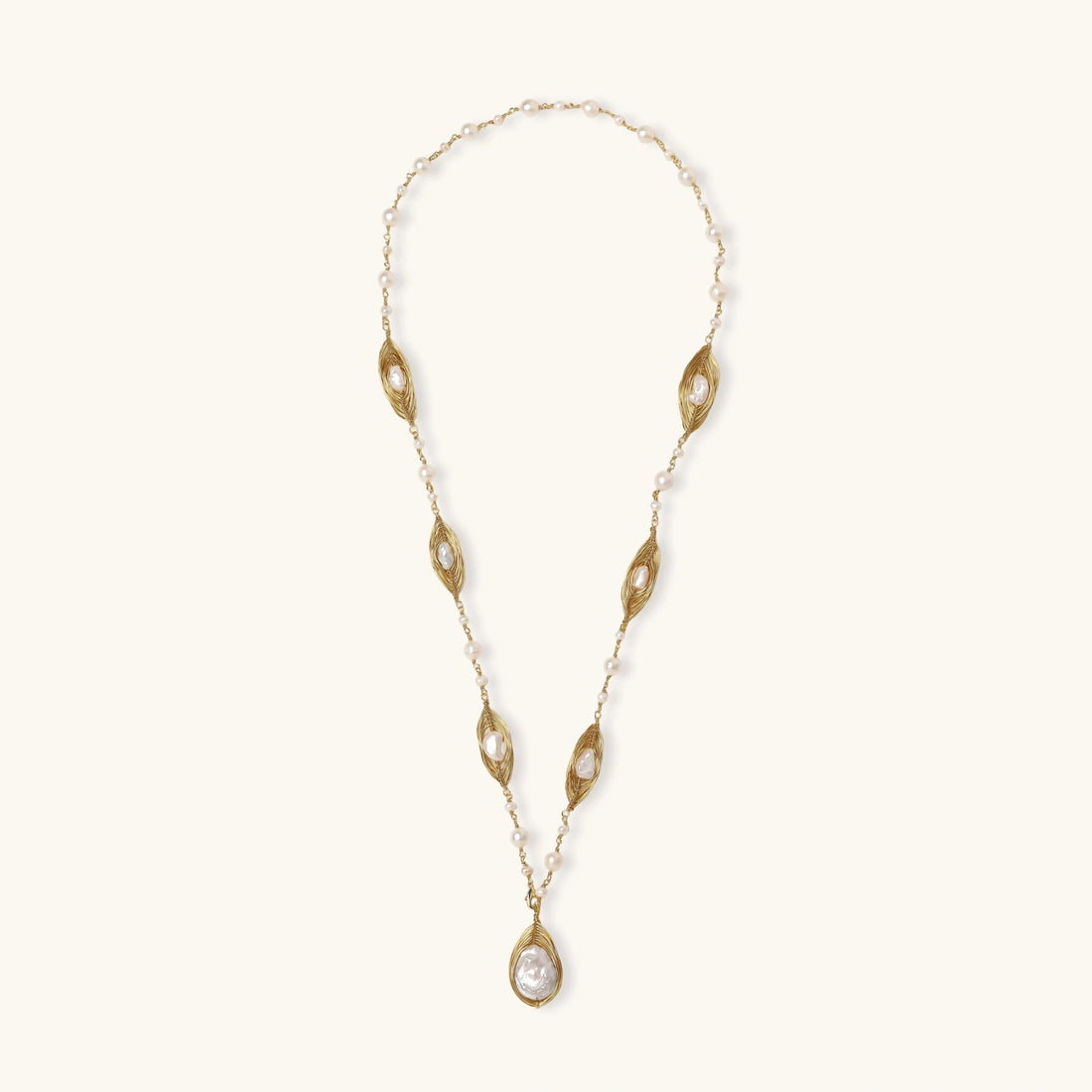 14K gold plated necklace with organic leaf motifs and freshwater pearls arranged in an elegant chain design on neutral background.