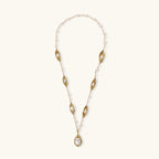 14K gold plated necklace with organic leaf motifs and freshwater pearls arranged in an elegant chain design on neutral background.