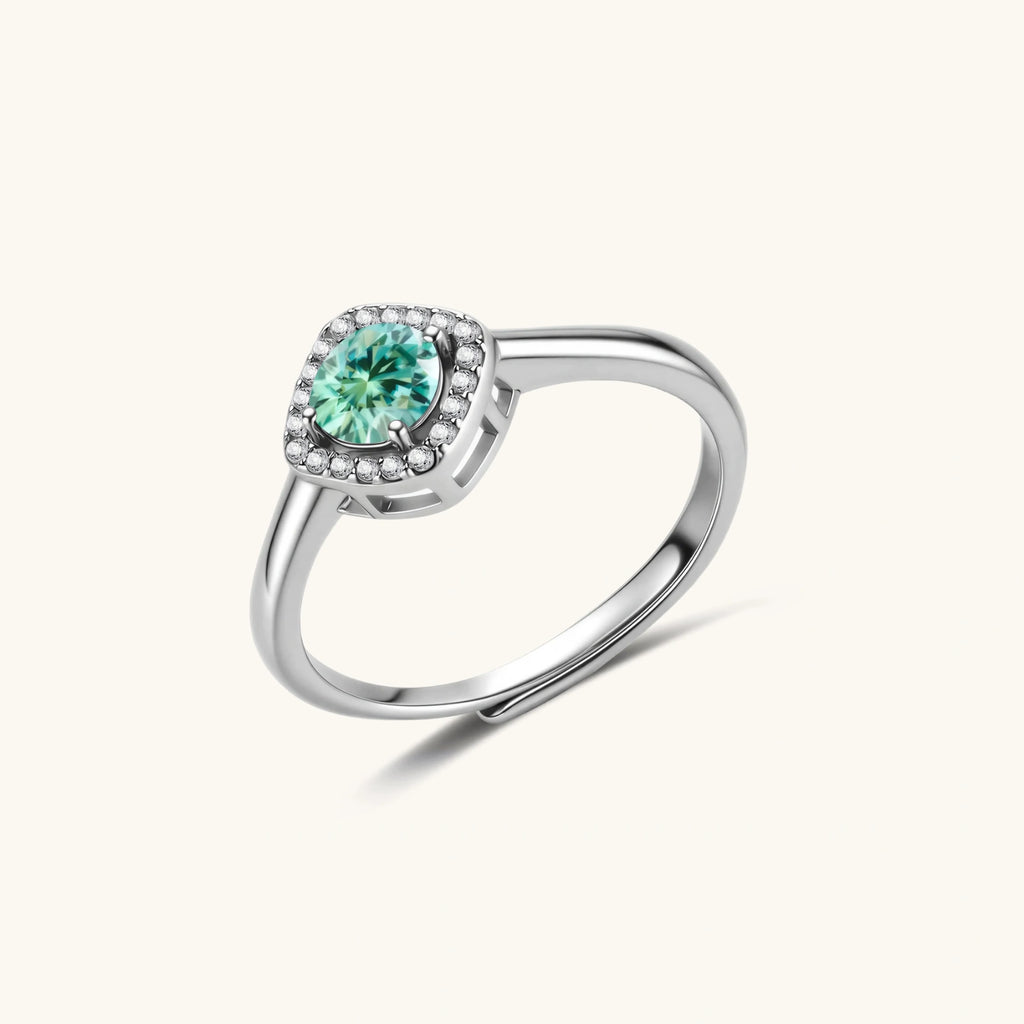 Sterling silver adjustable ring featuring round green moissanite center stone surrounded by clear halo stones