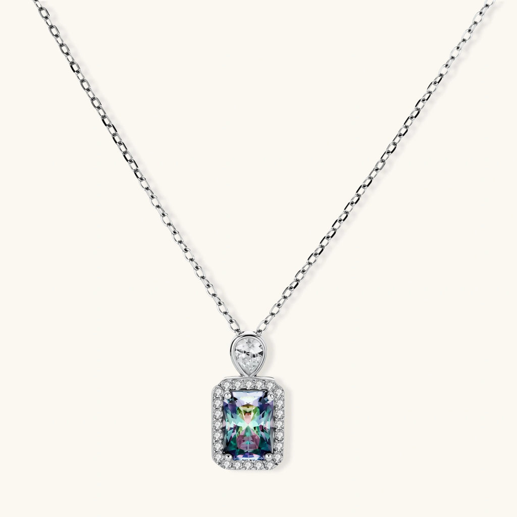 Sterling silver necklace with rectangular rainbow moissanite pendant and teardrop accent stone on white background