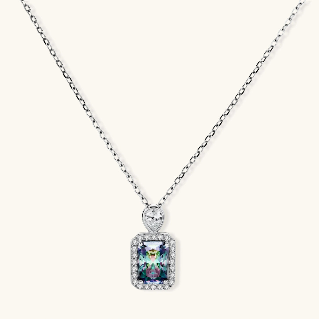 Sterling silver necklace with rectangular rainbow moissanite pendant and teardrop accent stone on white background