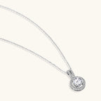 Platinum-plated sterling silver necklace with round halo pendant featuring central crystal surrounded by smaller stones