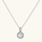 Platinum-plated sterling silver necklace with round halo pendant featuring central crystal surrounded by smaller stones