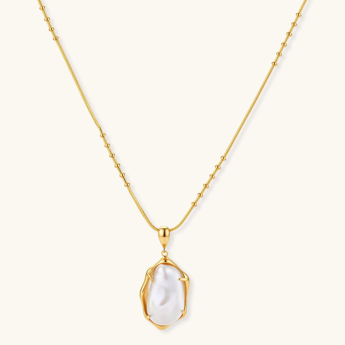 18K gold-plated sterling silver necklace with alternating bead chain and baroque pearl pendant on neutral background.