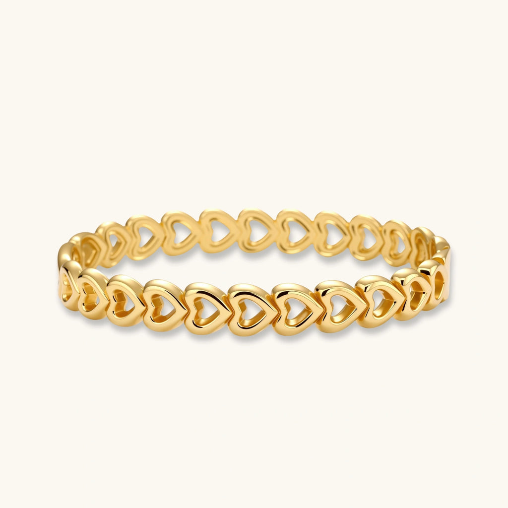 Gold 18K plated stainless steel bangle with continuous open heart links, high-polish finish, on white background.