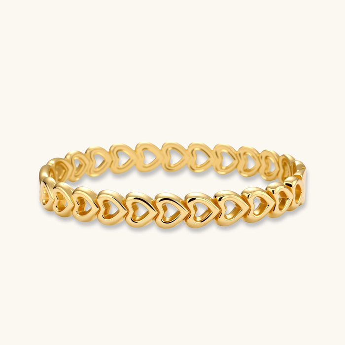 Gold 18K plated stainless steel bangle with continuous open heart links, high-polish finish, on white background.