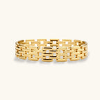Wide 18K gold plated stainless steel bracelet with a multi-row rectangular grid link chain pattern on a cream background.